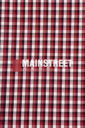 Red, black, and white plaid pattern with “MAINSTREET clothing destination” in white capitals near the center-left—evoking the classic Bisley Countryman Shirt made from durable polyester cotton fabric.