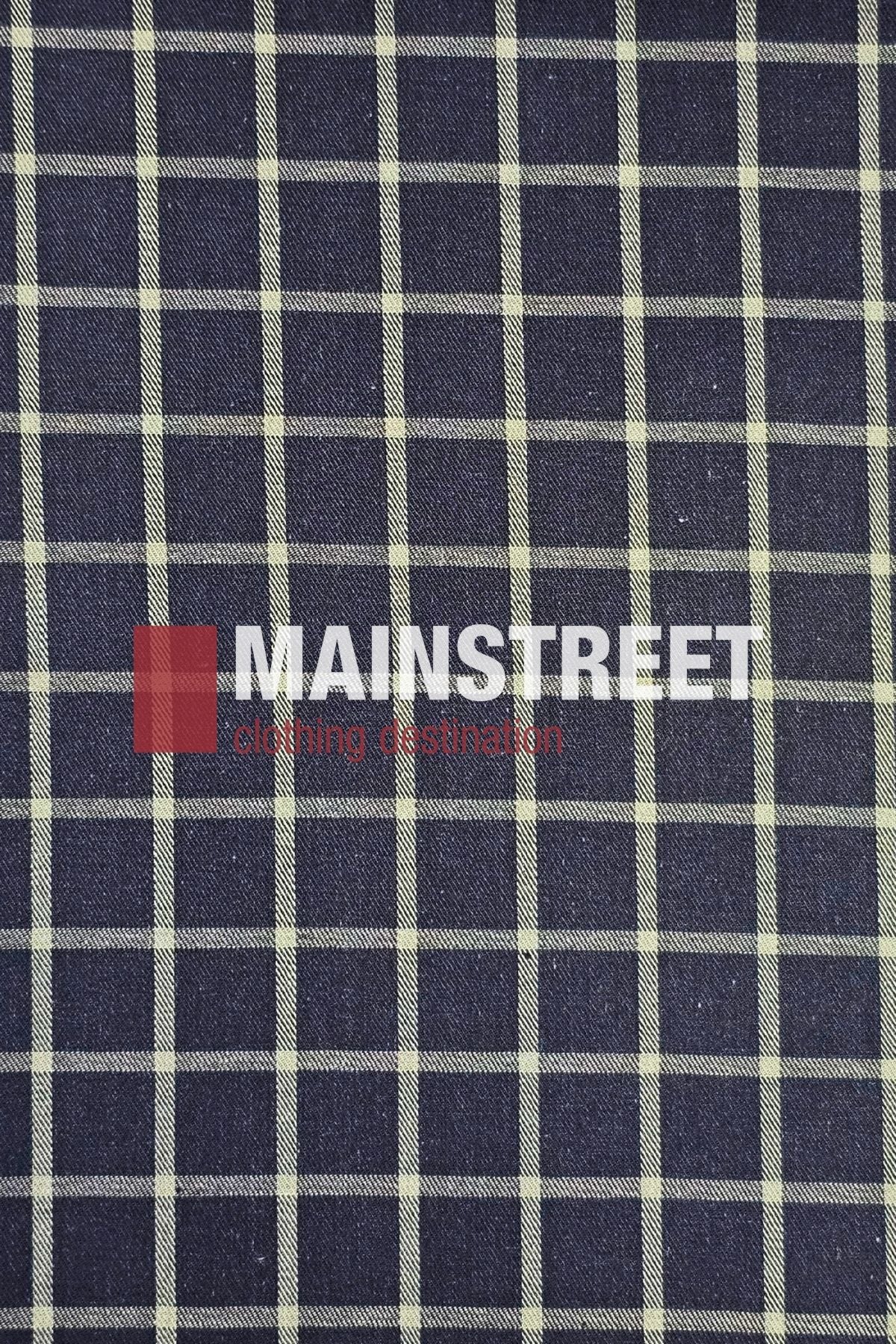 A navy blue Bisley fabric with a white check pattern. “MAINSTREET” appears in bold white text, with “clothing destination” below in red—an ideal backdrop for featuring the Bisley Countryman Cotton Shirt collection.