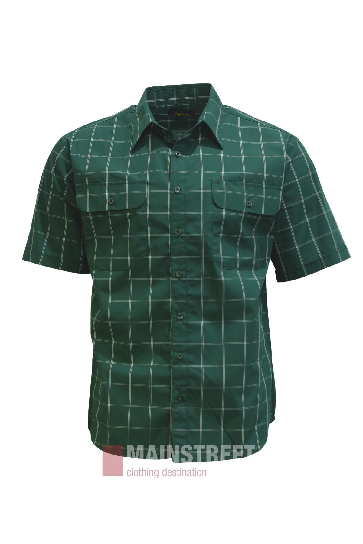 The Bisley Countryman Short Sleeve Shirt is a green, short-sleeve button-up featuring a white plaid pattern, two chest pockets, and the “Mainstreet clothing destination” logo at the bottom. Made from polyester cotton, this versatile shirt is displayed on a plain white background.