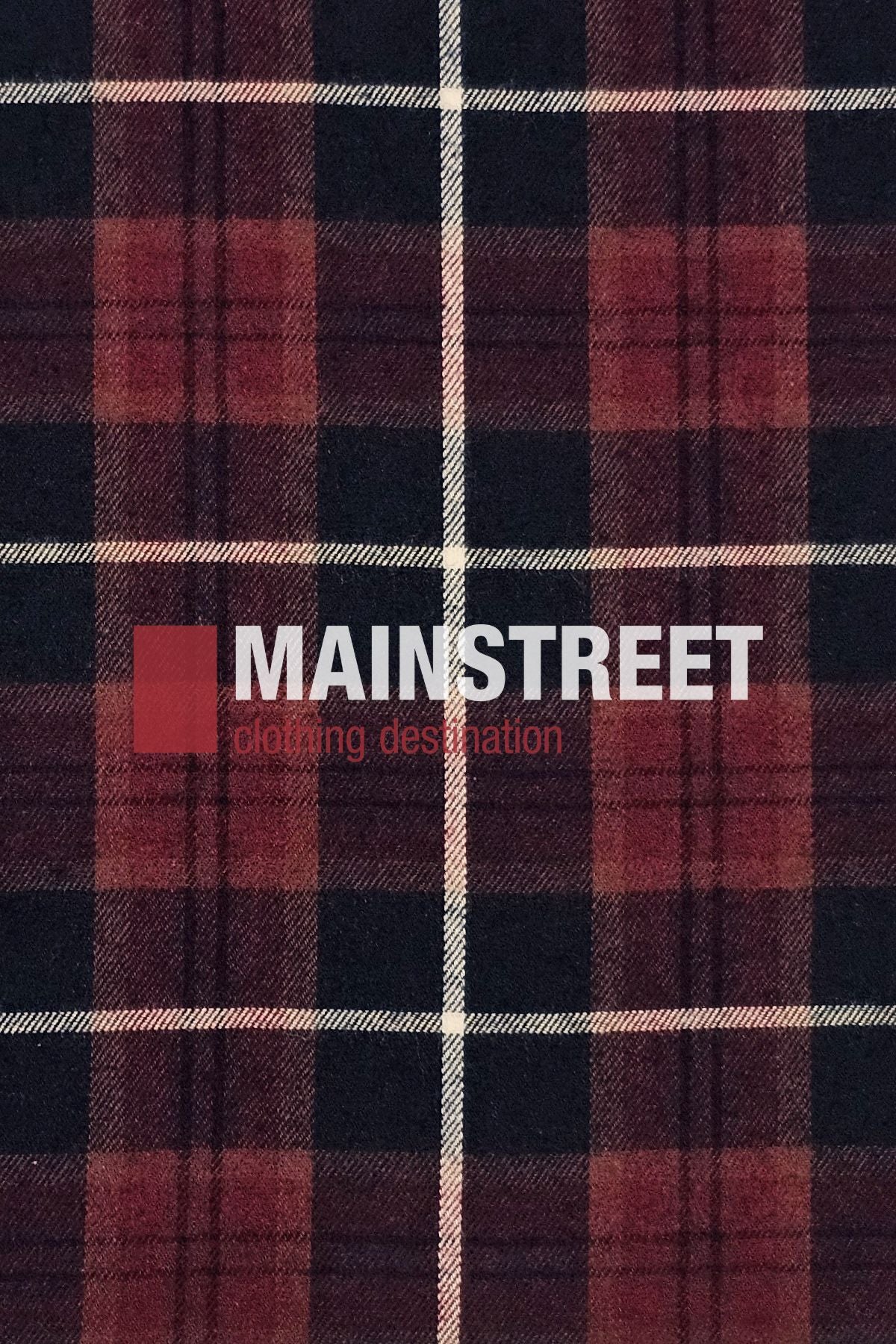 A close-up of the Bisley Countryman Brushed Shirt, featuring a red and black plaid polyester-cotton blend with white stripes. "MAINSTREET clothing destination" is printed in white and red across the center.