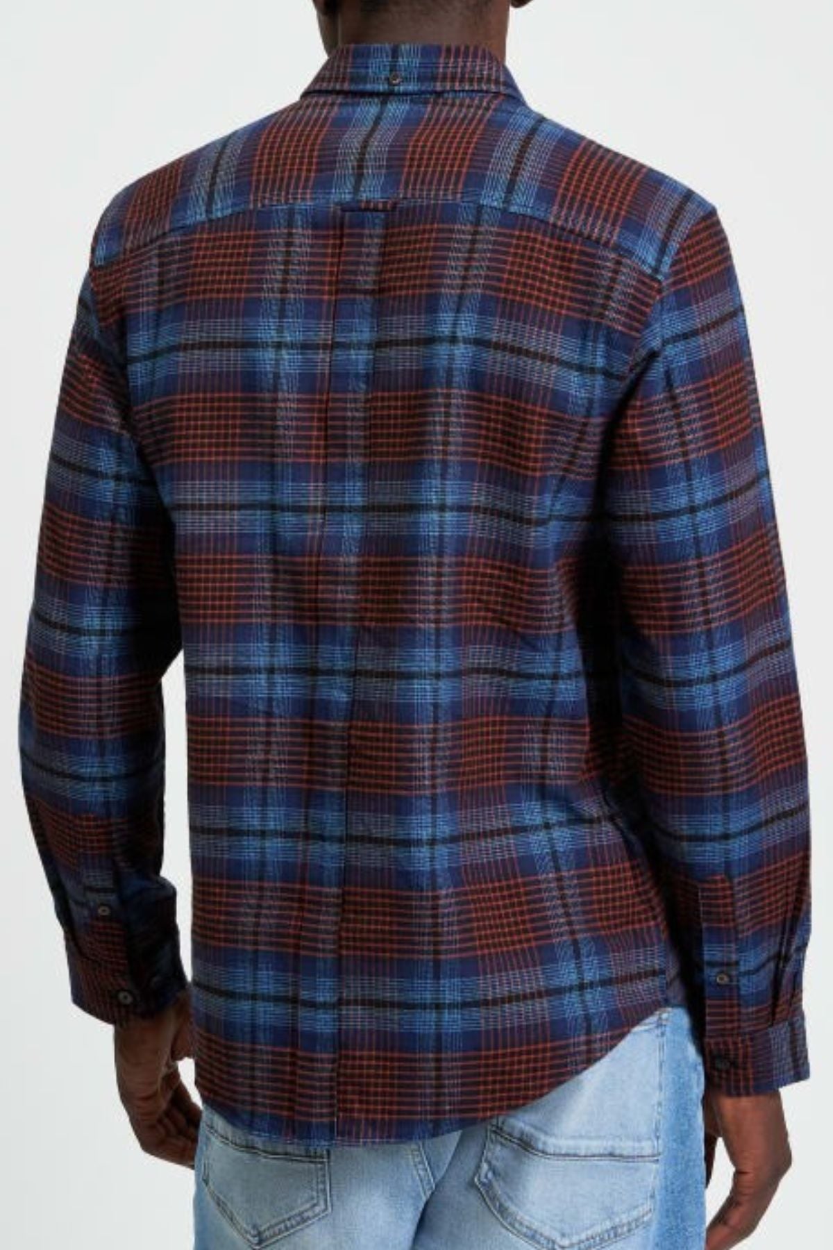 A person seen from behind wears the Ben Sherman Ombre Check Shirt, a long-sleeved blue and red plaid top, styled with light blue jeans against a plain background.