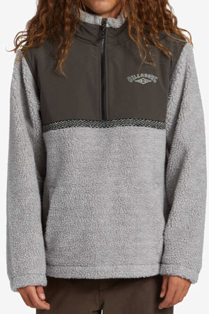 Someone in the Billabong A/DIV Boundary Re-Issue Sweatshirt—a gray pullover with a dark chest panel, half-zip collar, and patterned trim—makes a great choice for outdoor adventures. Features the Billabong logo.