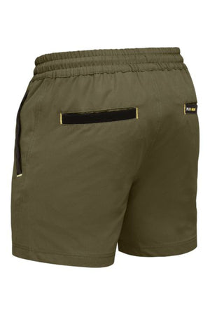 The Bisley Flex & Move 4 Way Stretch Elastic Waist Short comes in olive green with an elastic waistband, black drawstring, durable Cordura-trimmed back pocket, and a small rectangular label near the right waistband for style.