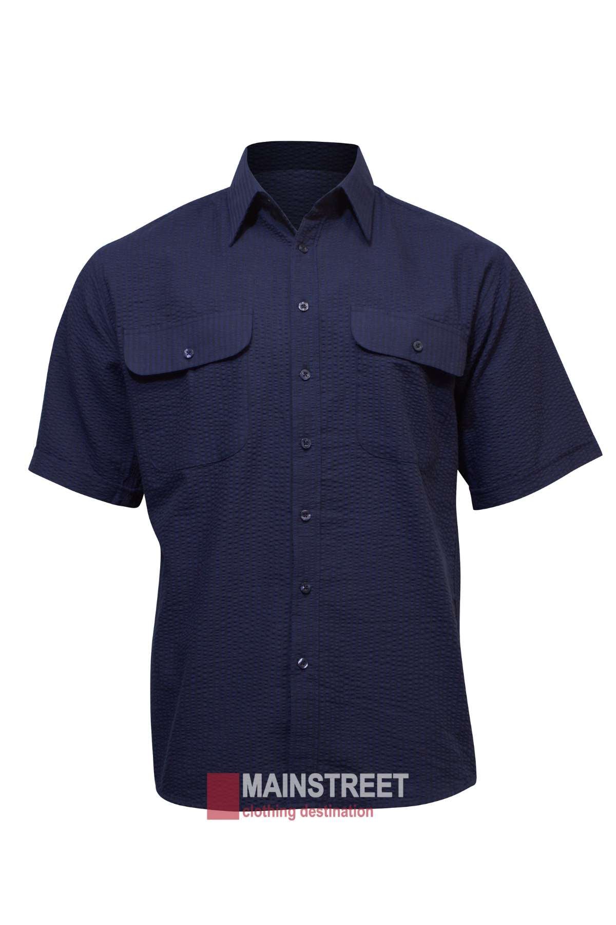 A dark blue, short-sleeve button-up Bisley Countryman Seersucker Short Sleeve Shirt with two chest pockets, displayed on a white background. The well-ironed shirt, made of a Polyester/Cotton blend, has all buttons fastened. The background features the "MAINSTREET clothing destination" logo at the bottom.