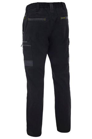 The Bisley Flex & Move Stretch Canvas Elastic Waist Cargo Pant shown from the back highlights multiple pockets, reinforced Cordura® fabric, and yellow stitching details on the waistband and pocket areas.