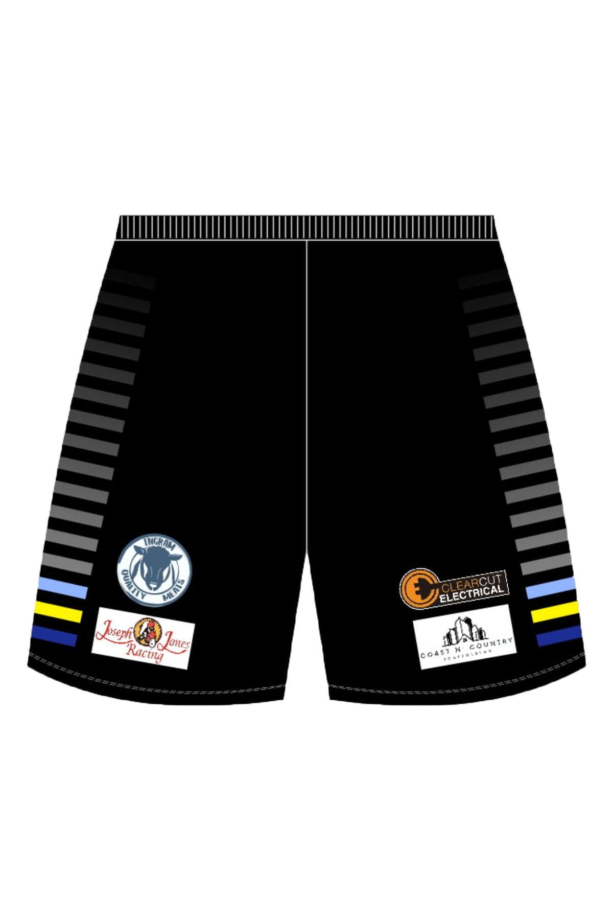 Black Bombala Blue Heelers training shorts feature gray side stripes, zip pockets, logos for "Raw," a mountain graphic, "Stone Property Services," and "Del High Country Fireworks" with a firecracker image. They have thin blue and yellow bands at the bottom of the stripes.