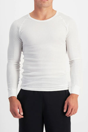A person wears the Bonds Aircel Long Sleeve Tee in white with black pants, standing against a plain white background. The person's head is partially out of frame.