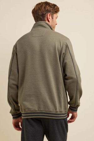 Seen from behind, a person with short hair wears the Breakaway Kyler Snowy Mt Fleece Half Zip in green and dark pants. This soft and warm fleece jacket features a high collar and visible seam details along the shoulders and arms. The background is a plain, light-colored wall, making it perfect for winter.