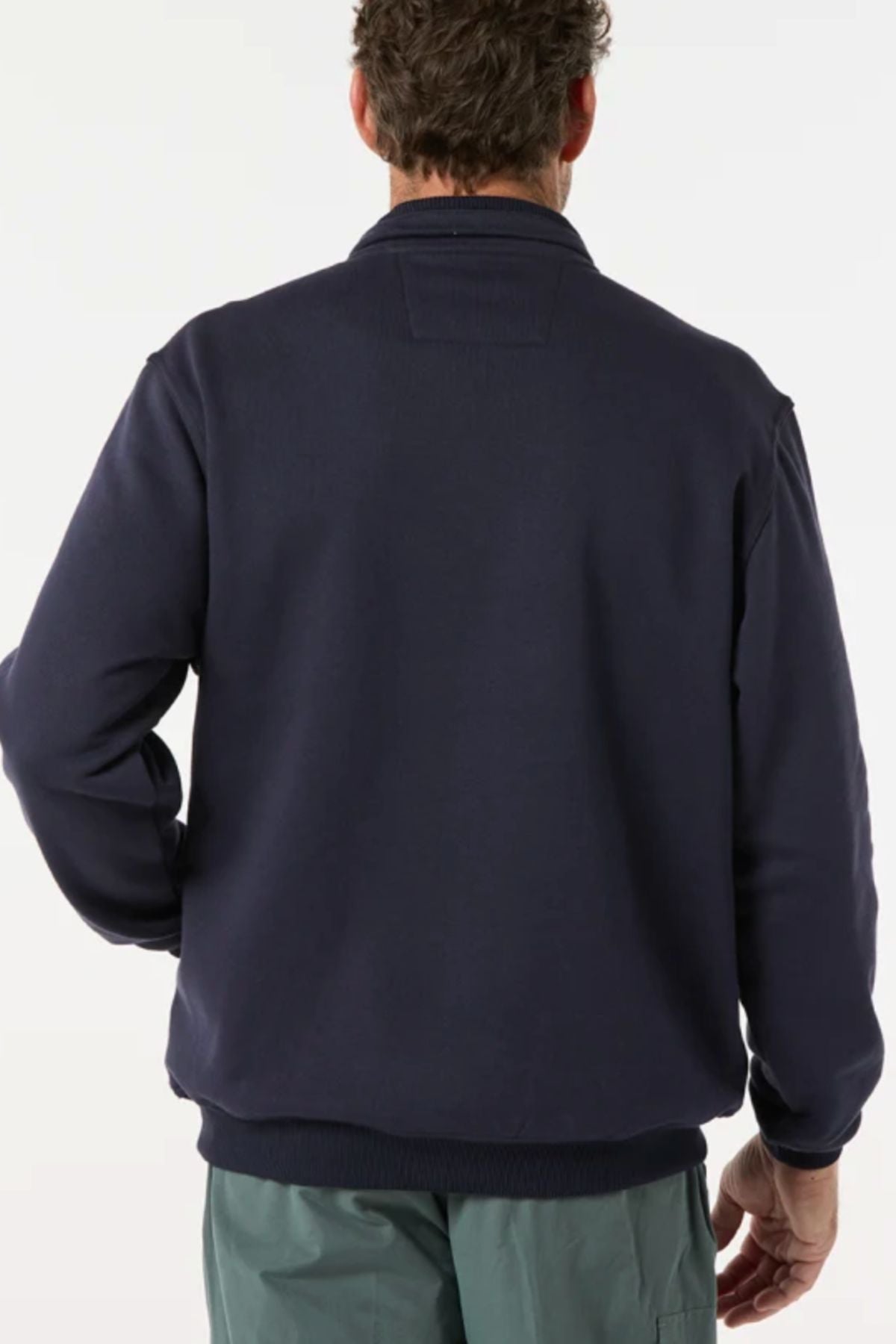 A person is shown from the back wearing a navy Breakaway Zed Snowy Mt Fleece Half Zip and light green pants against a plain light background.