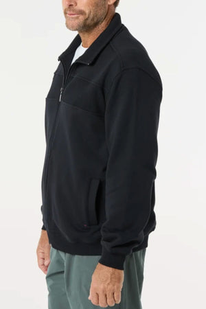 A man wears the Breakaway Zed Snowy Mt Fleece Jacket with a collar and side pockets, paired with green pants, against a plain white background—the perfect layering piece for cooler days.