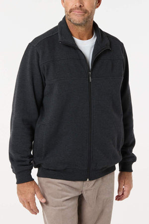 A man stands facing forward with his hands at his sides, modeling the Breakaway Zed Snowy Mt Fleece Jacket over a white tee and beige pants against a plain white background—ideal winter wear for snowy mountain adventures.