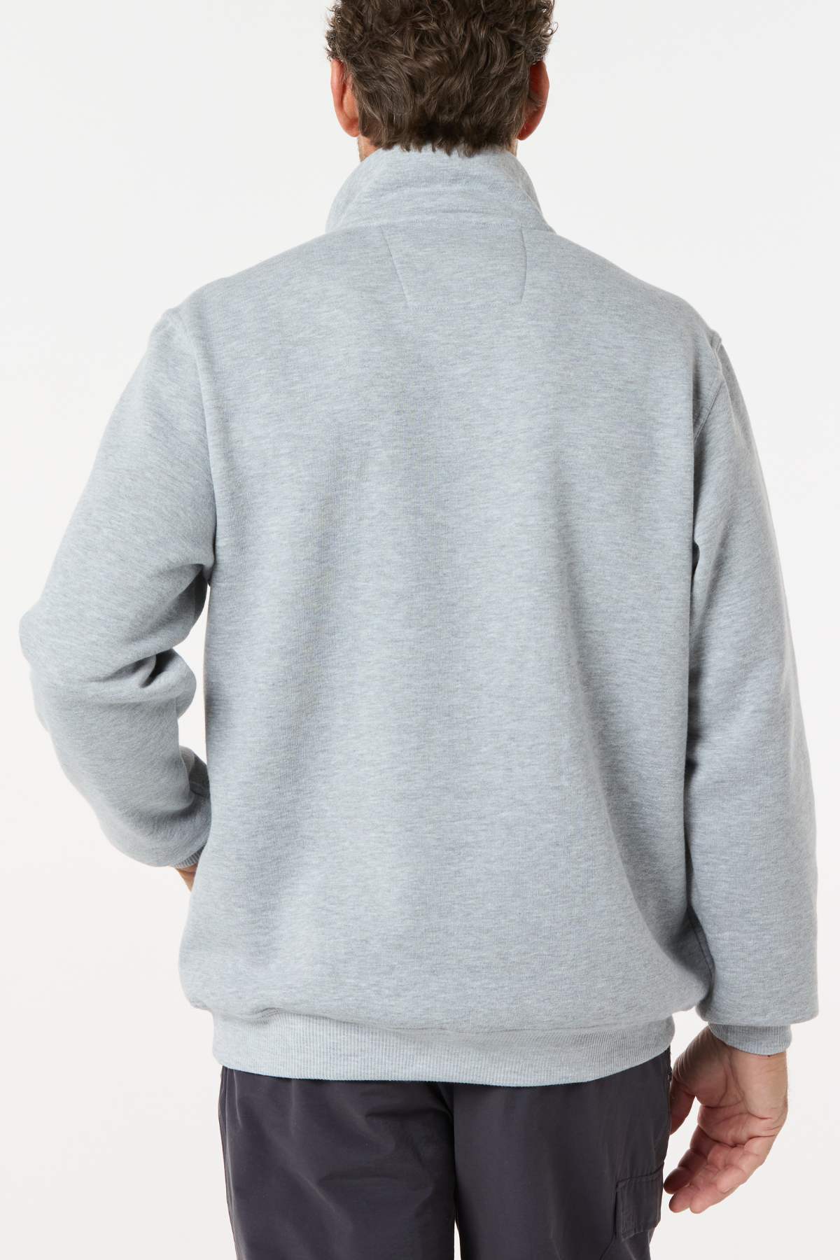 A man stands with his back to the camera in a light gray Breakaway Zed Snowy Mt Fleece Half Zip pullover and dark pants, set against a plain white background.
