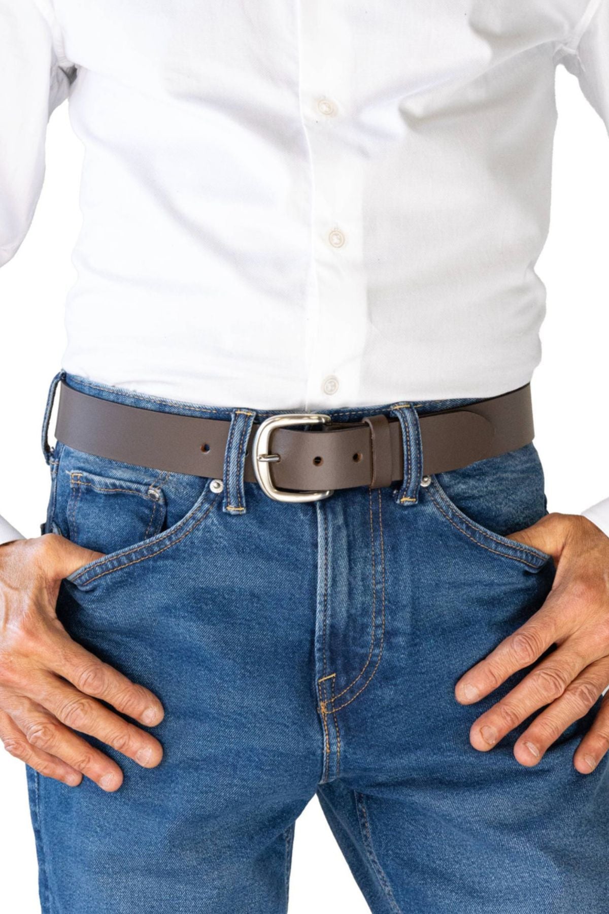A person wears a white button-up shirt tucked into blue jeans, accessorized with the Buckle 5092 Buffalo Top Grain Belt. Their hands rest on their hips, and the image is cropped from the shoulders down.