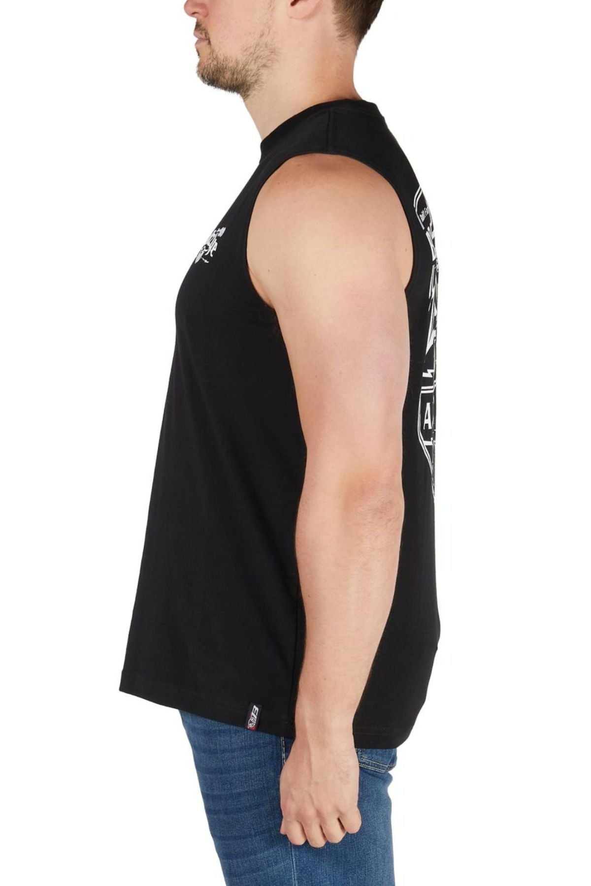 Wearing a Bullzye Brewin Dust Muscle Tank and blue jeans, a man stands in profile against a white background, highlighting this stylish men's casual wear.