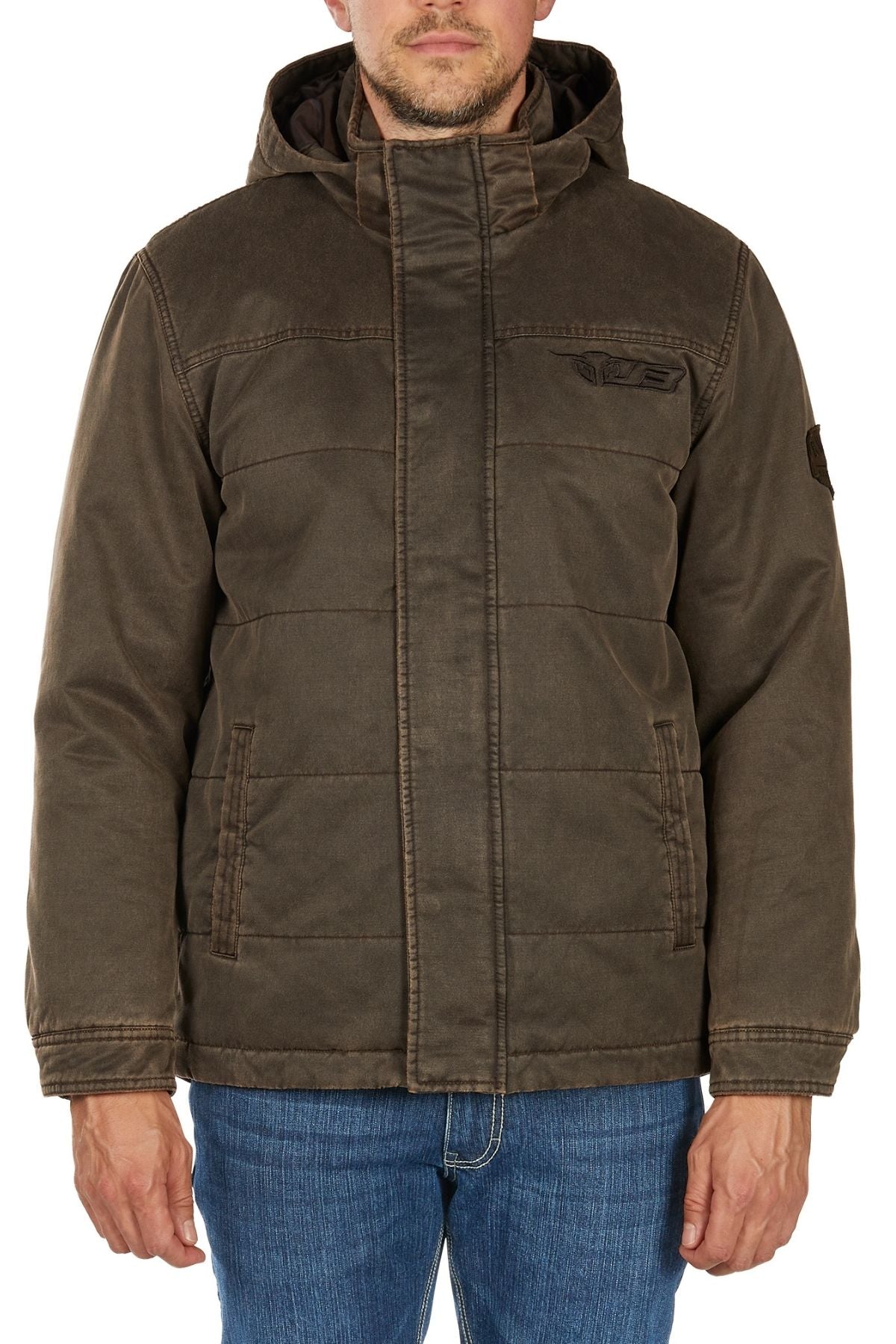 A man wearing the Bullzye Canon Jacket, a brown hooded puffer with front pockets, and blue jeans stands facing forward against a white background.