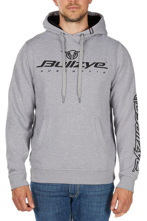 A man wearing the Bullzye Determination Hoodie—a light gray premium hoodie with bold "BULLZYE AUSTRALIA" graphics on the chest and sleeve logo—paired with blue jeans.