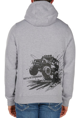 A person faces away from the camera, wearing the Bullzye Determination Hoodie. The back displays bold graphics of an off-road monster truck splashing mud and the phrase “DUST & DETERMINATION,” combining style with premium comfort.