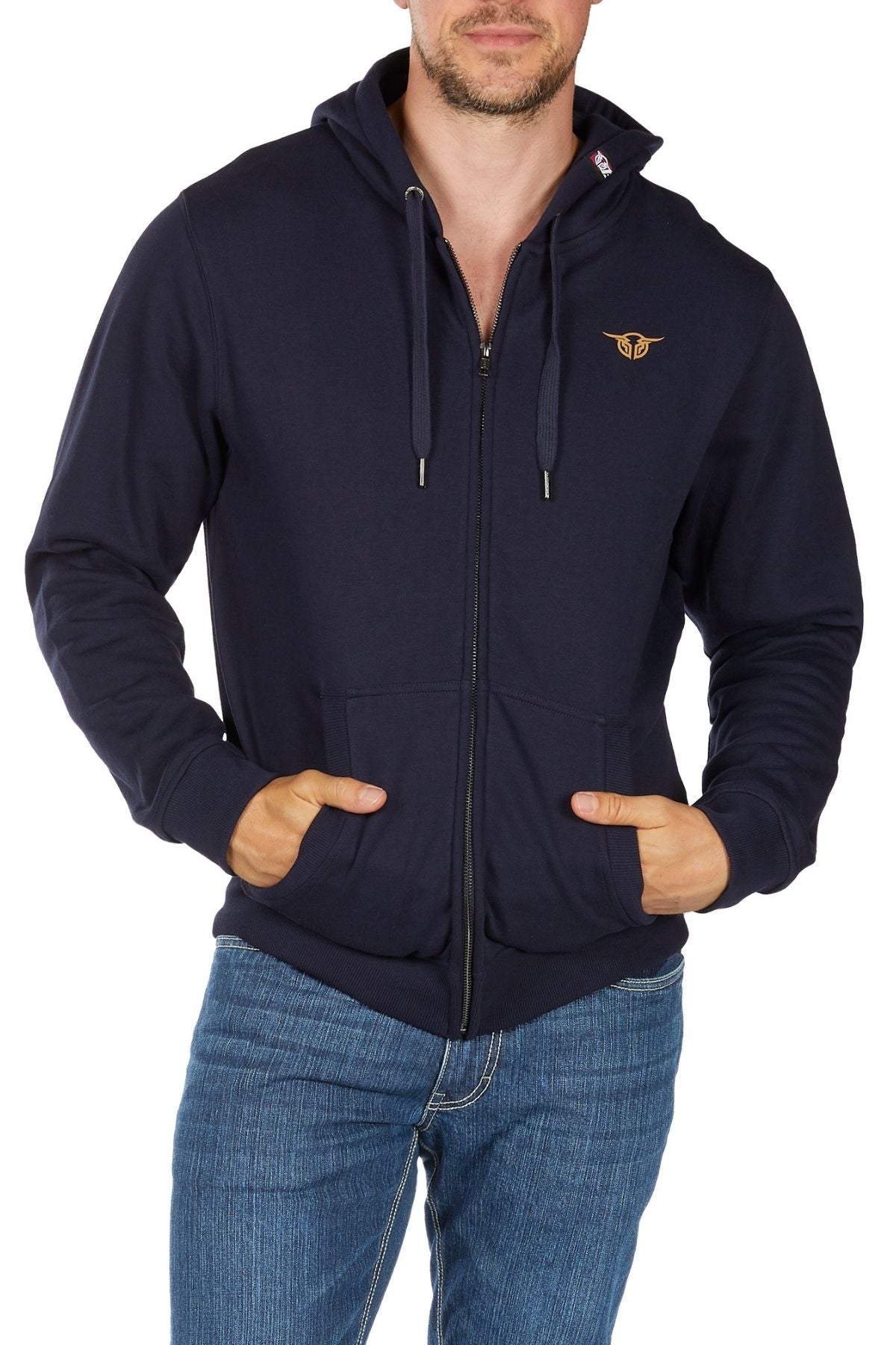 A man wearing the Bullzye Hardy Zip Up Hoodie in navy with a small chest logo and blue jeans stands with his hands in the hoodie pockets against a plain white background.
