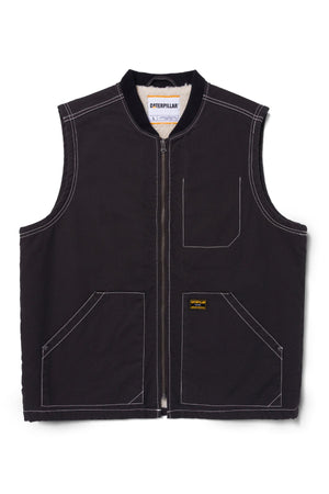 The CAT Canvas Utility Sherpa Lined Vest is black, sleeveless, and features a front zipper, two large front pockets, a small chest pocket, white contrast stitching, and a Caterpillar brand label on the front.