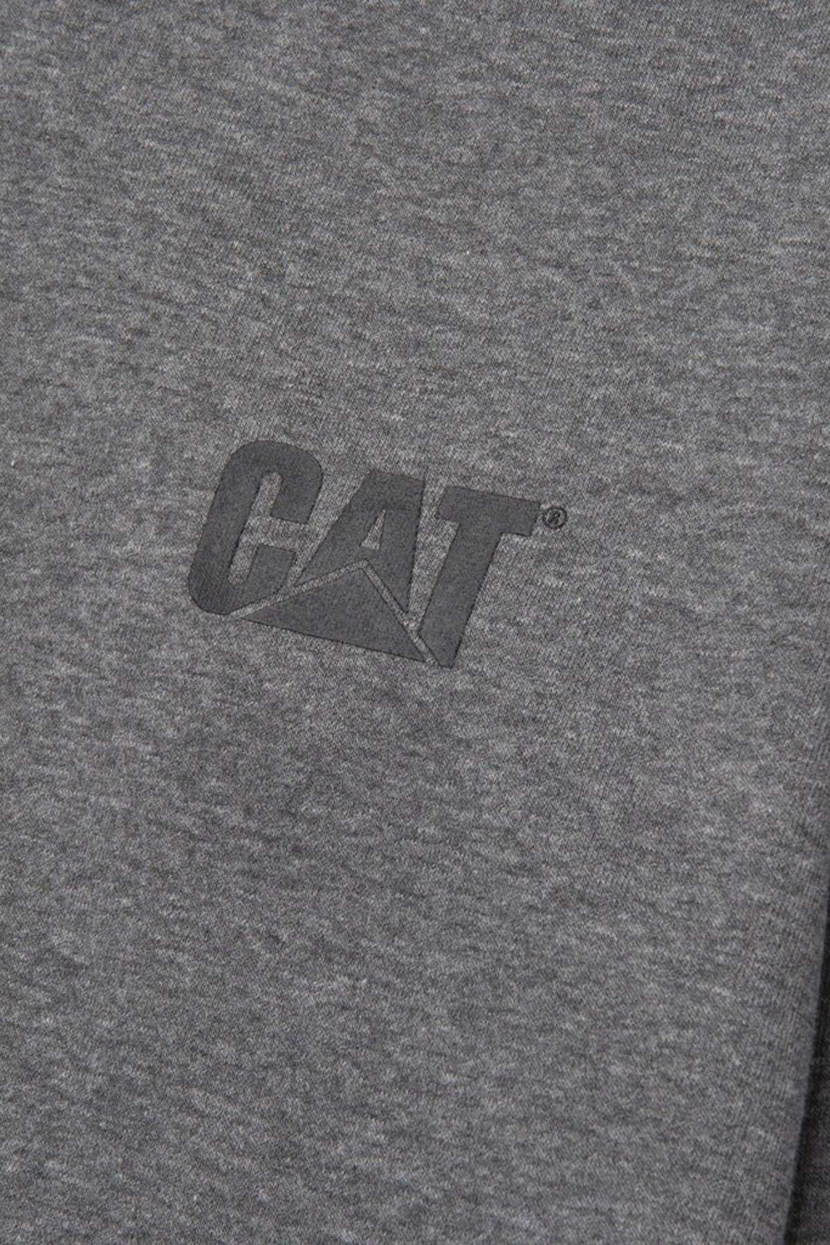 A close-up photo of a gray fabric with the "CAT" logo printed in black on it. The texture of the CAT Essential 1/4 Zip Sweatshirt is visible, showcasing the super soft fleece lining. The logo features the stylized letters "C," "A," and "T," with the letter "A" forming a triangular shape.