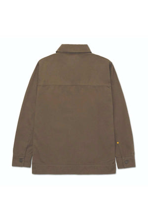 The CAT Heritage Uniform Twill Shirt Jacket is shown from the back in brown cotton twill, featuring a straight hem, long sleeves with buttoned cuffs, and a simple collar. The sturdy fabric ensures durability for outdoor work.