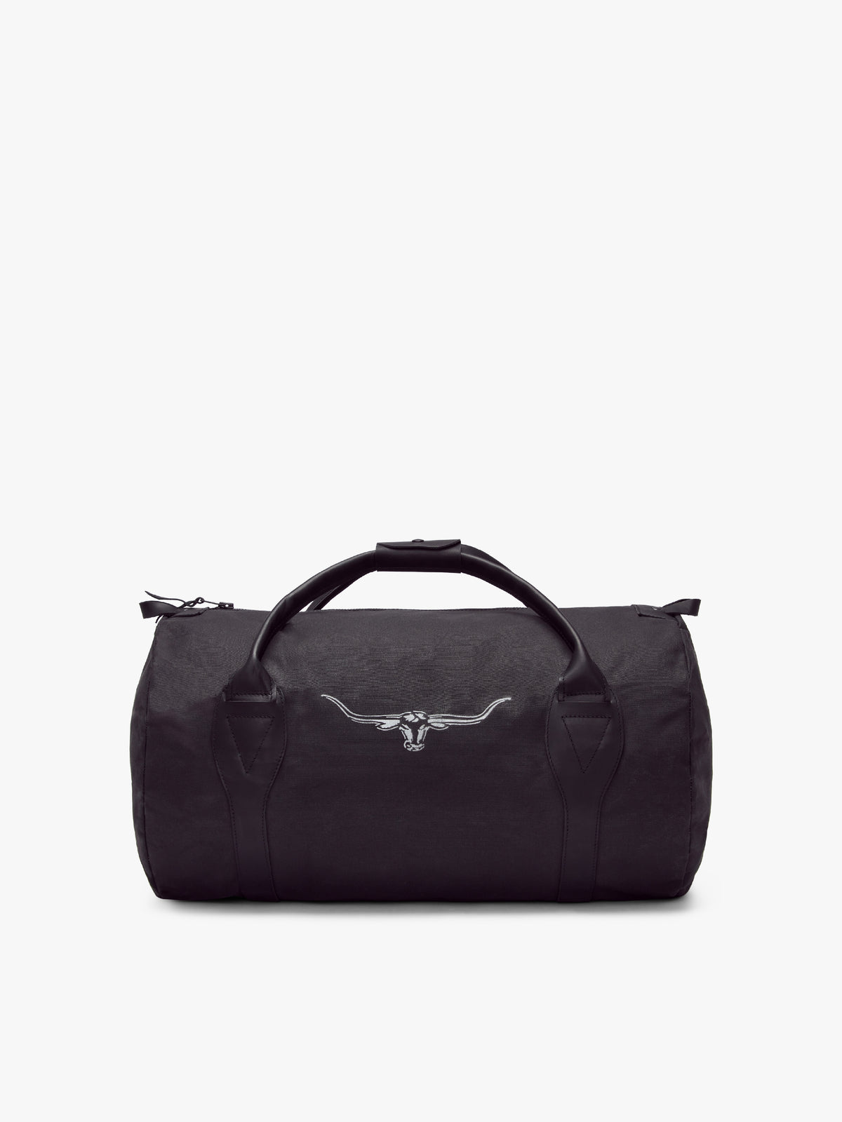The RM Williams Canvas Ute Bag is a black duffel with water-resistant fabric, two leather handles, a top zipper, and a white embroidered longhorn skull on the front, shown against a plain white background.