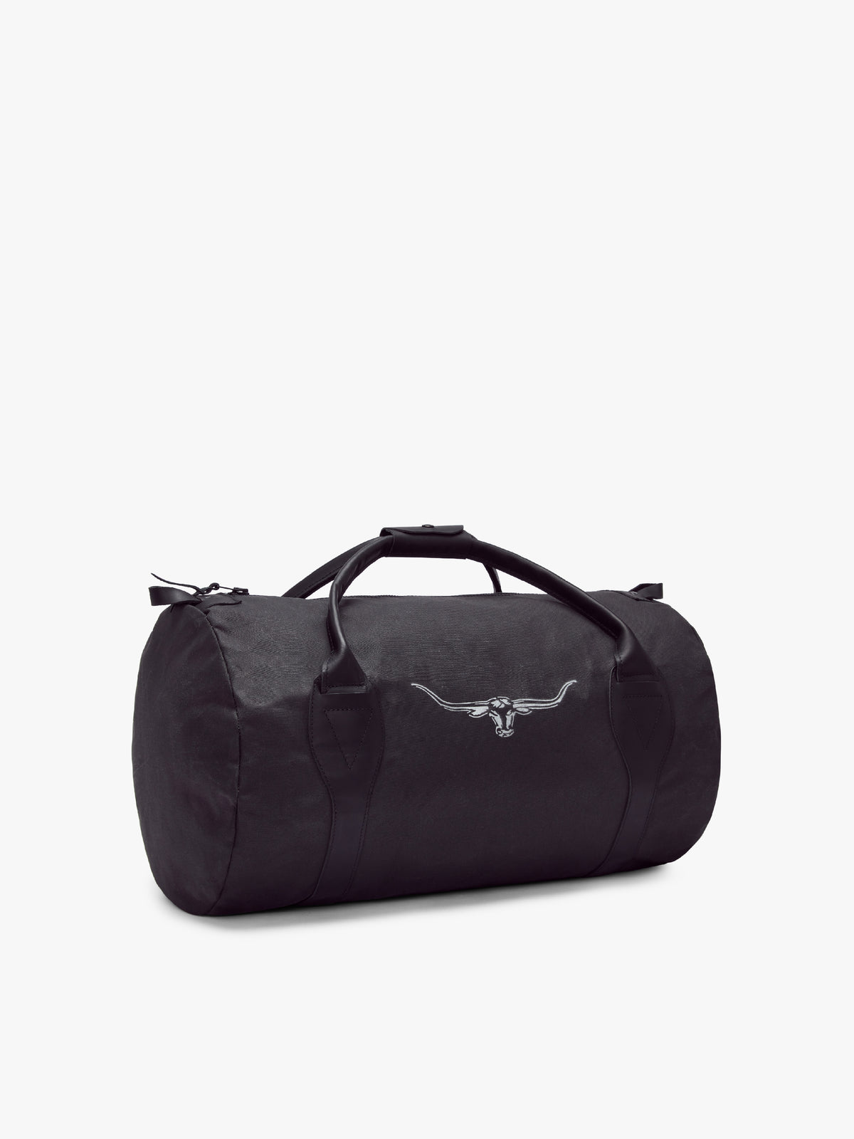 The RM Williams Canvas Ute Bag is a black duffel with water resistant fabric, leather handles, side zipper, and a white bull head logo on the front. It is displayed on a plain white background.