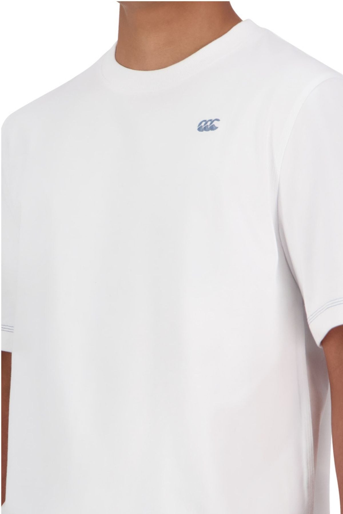 Model is wearing the Canterbury CCC Collection T-Shirt, a plain white tee with a small blue "CCC" logo on the left chest. It features a crew neckline, simple stitching, and an oversized fit for relaxed comfort.