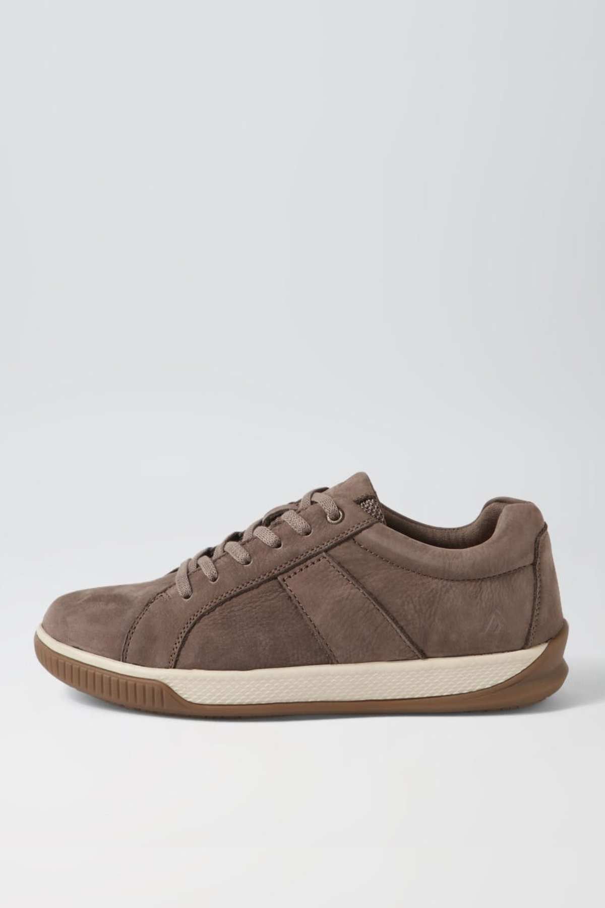 The Colorado Edo Sneaker, a brown suede casual shoe with a lace-up design, beige midsole, and brown rubber outsole, is showcased against a plain light-colored background.