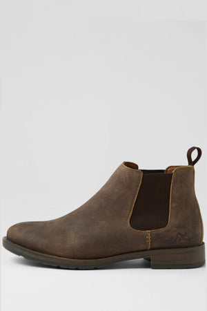 The Colorado Lizard Oil Suede Boot features brown oiled suede, elastic side panels, a back pull tab, low heel, durable sole, and a subtly worn finish. It is displayed against a plain light gray background.