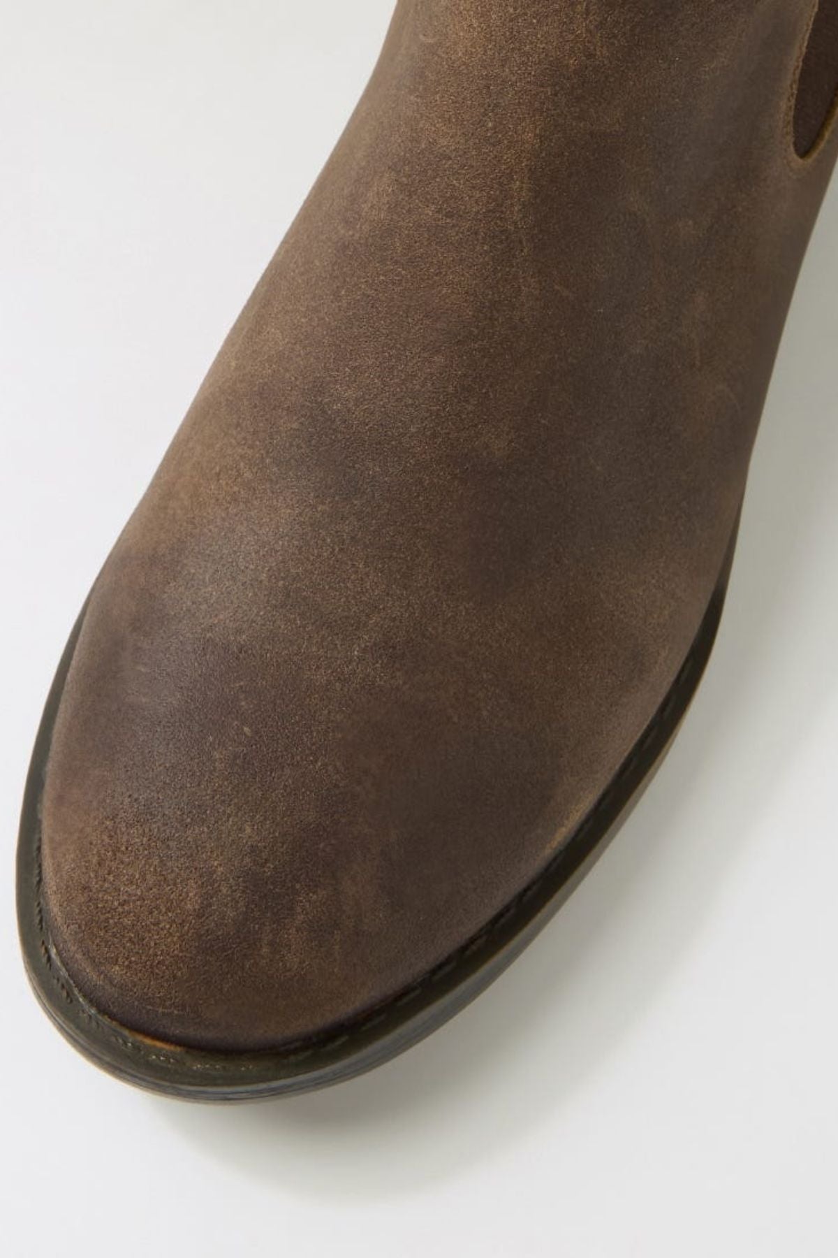 Close-up of the toe and upper part of the Colorado Lizard Oil Suede Boot, showcasing its brown oiled suede with a slightly worn texture and rugged style, set against a plain white background.