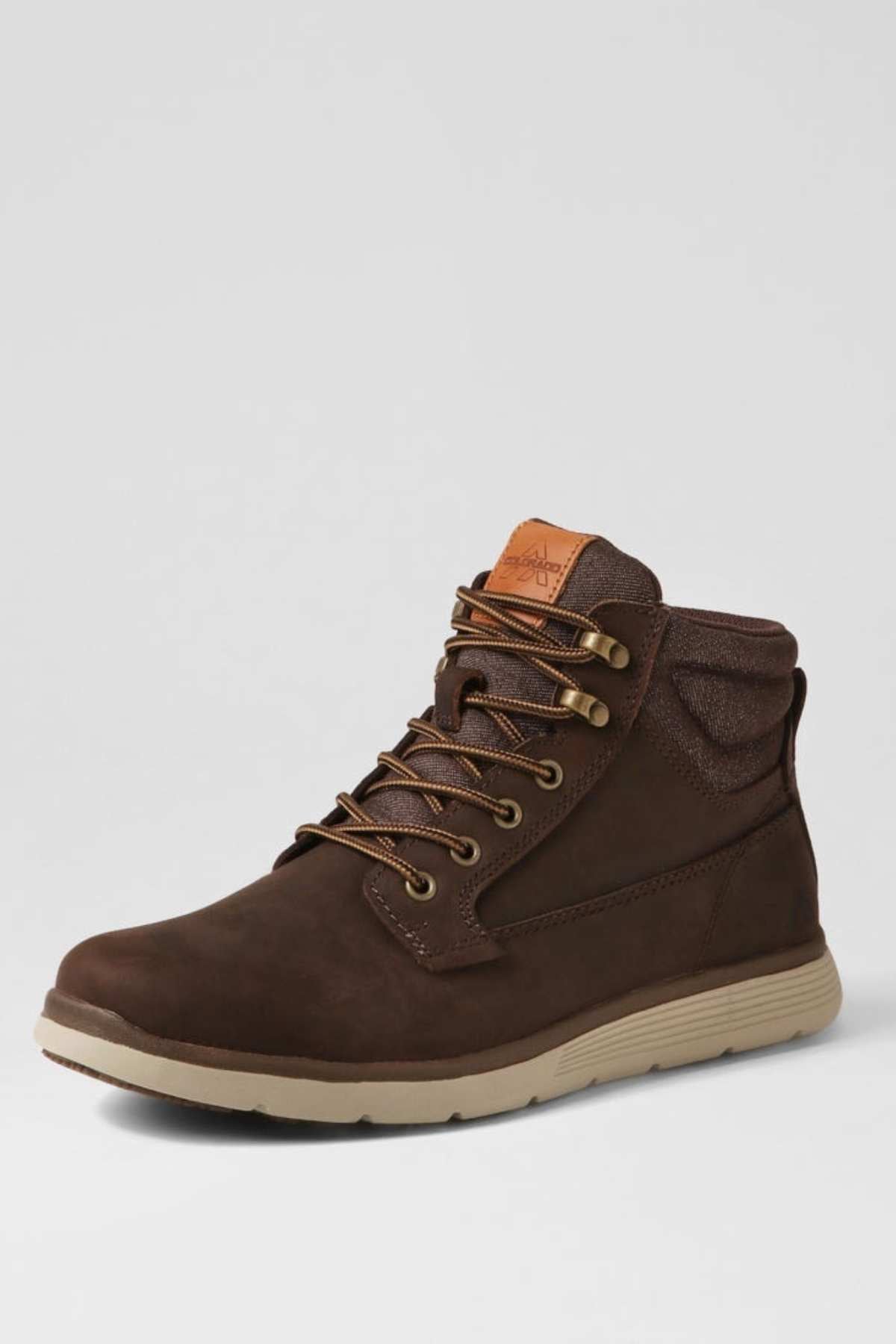 A single brown Colorado Yrbud Boot, featuring a padded collar, tan outsole, shock-absorbing midsole, and tan logo patch on the tongue, is displayed facing left against a light gray background.