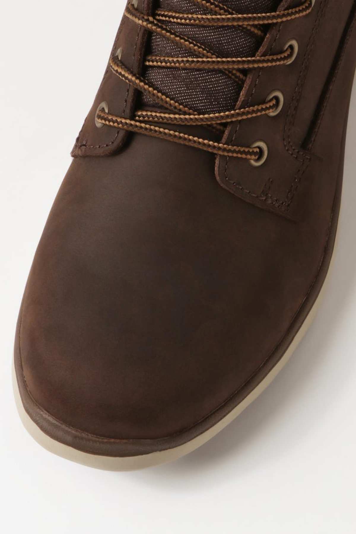 Close-up of the Colorado Yrbud Boot, featuring brown leather, tan and brown laces, metal eyelets, and a beige slip-resistant rubber sole, photographed on a light background.