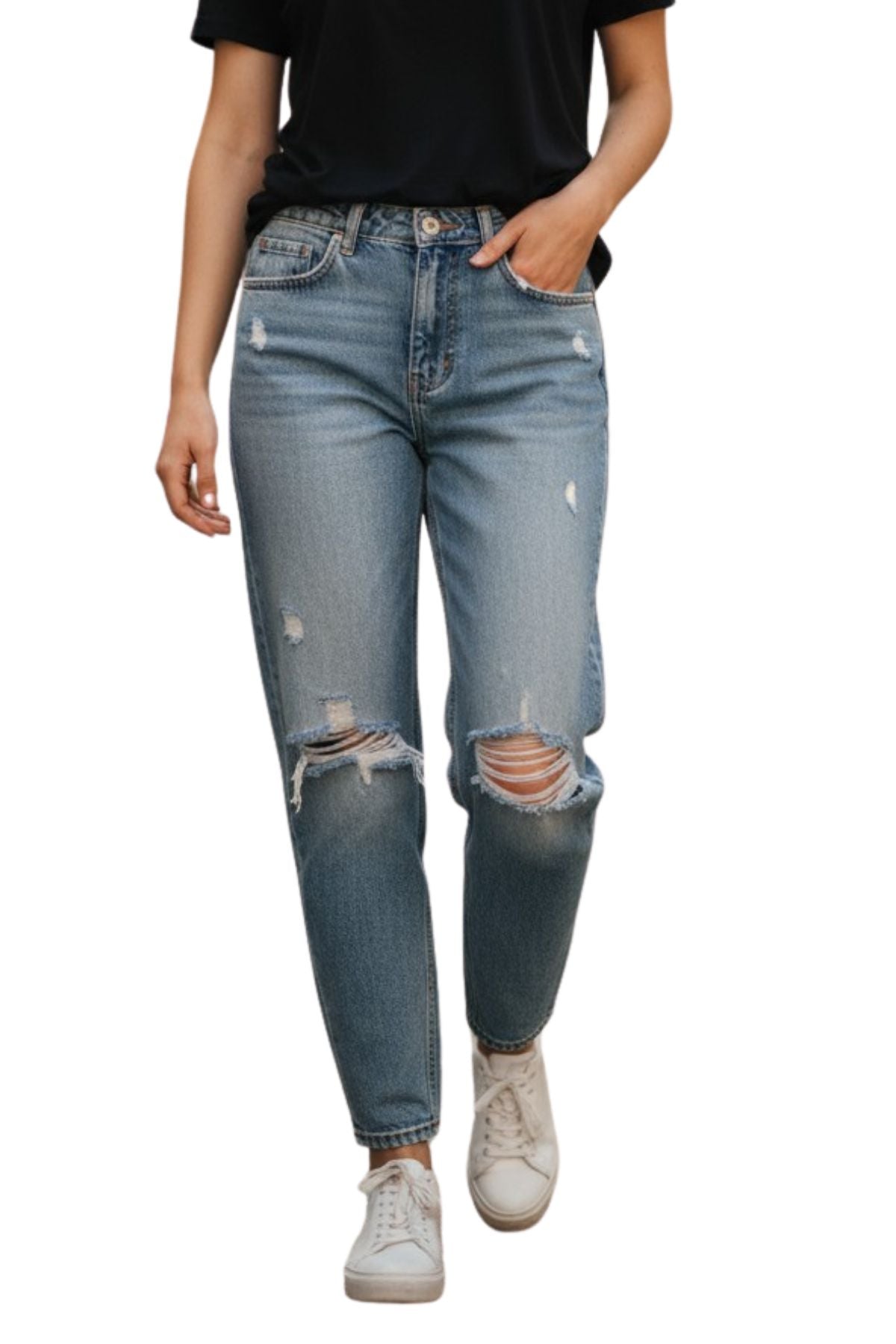 A person wearing a black t-shirt, Country Denim Relaxed Mum Jean, and white sneakers with one hand in their pocket walks forward against a white background, showcasing a laid-back country denim vibe.