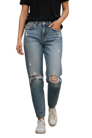A person wearing a black t-shirt, Country Denim Relaxed Mum Jean, and white sneakers with one hand in their pocket walks forward against a white background, showcasing a laid-back country denim vibe.