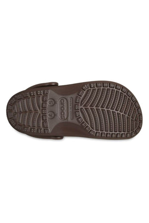 A bottom view of the brown Crocs Classic Clog shows its textured sole with tread patterns and US size markings (5 and 7)—ideal for water adventures or anyone who loves lightweight, breathable clog footwear.