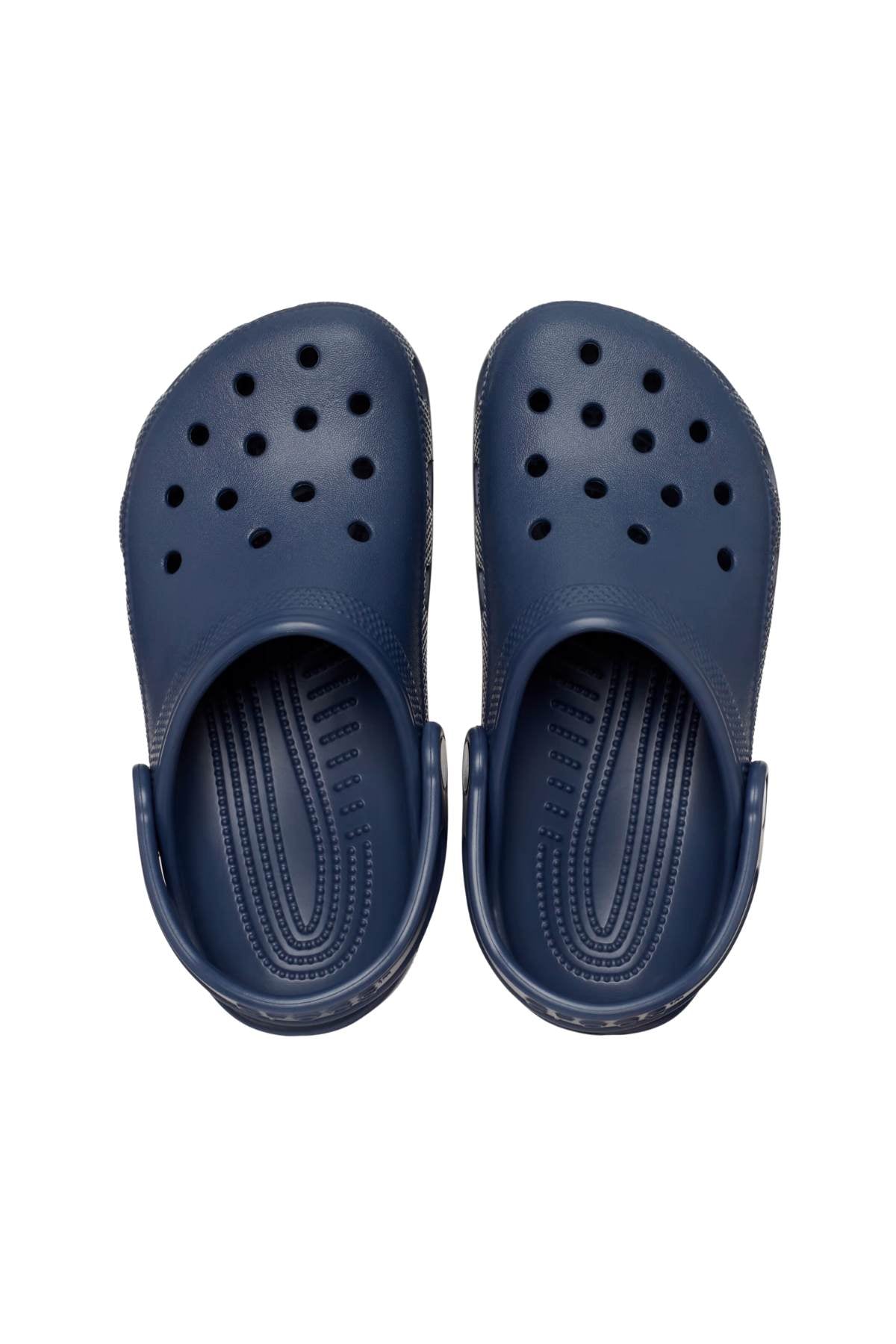 A pair of navy blue Crocs Classic Kids Clog, showcasing multiple ventilation holes on the top, is displayed from an overhead perspective against a white background. Made from Croslite™ material, these clogs offer the renowned Crocs Comfort™ with a cushioned insole and a back strap for support.