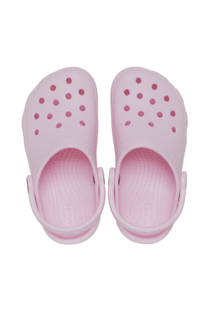 The Crocs Classic Kids Clog in light pink features ventilation holes and adjustable back straps, shown from above on a white background—ideal, comfortable everyday shoes for kids.