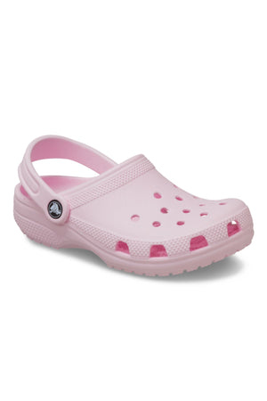 The Crocs Classic Kids Clog in light pink features ventilation holes, a textured sole, and a pivoting heel strap for comfort—ideal kids’ shoes—displayed on a plain white background.