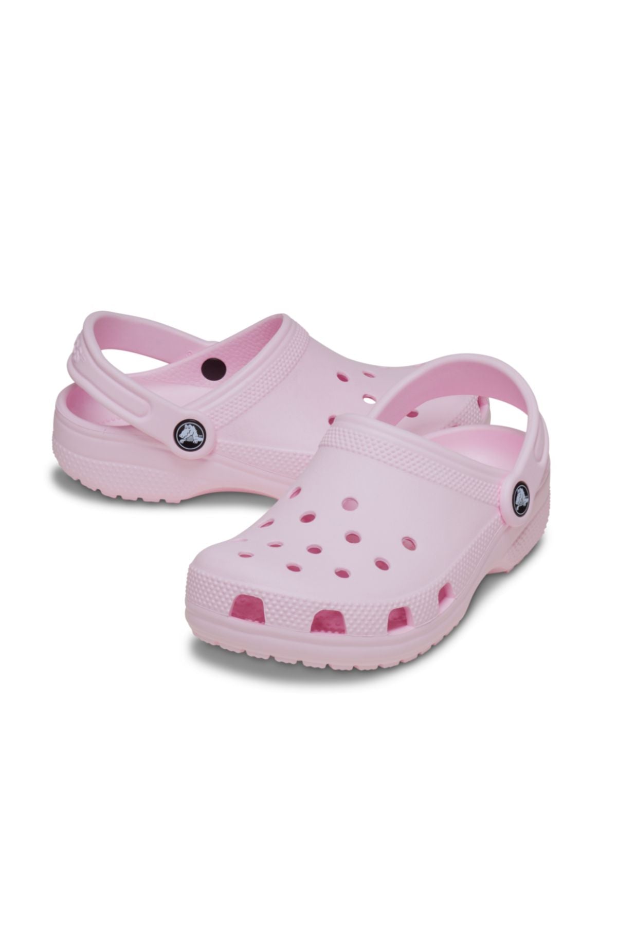 Light pink Crocs Classic Kids Clog with ventilation holes and adjustable back straps, displayed on a white background—ideal comfortable shoes for kids' everyday wear.