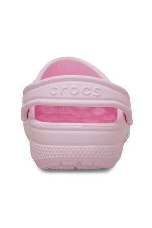 Rear view of the Crocs Classic Kids Clog in light pink features a heel strap with an embossed "Crocs" logo and textured sole—ideal comfy shoes for kids’ daily adventures.