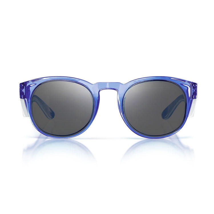 The SafeStyle Cruisers Blue Frame Tinted Lens sunglasses feature round, blue-transparent polycarbonate frames and dark tinted lenses, shown on a white background with a subtle reflection underneath.