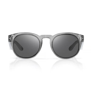 A pair of stylish sunglasses with transparent frames and dark-tinted lenses, viewed from the front against a plain white background. The SafeStyle Cruisers Graphite Frame Tinted Lens design exhibits a modern and minimalist aesthetic.