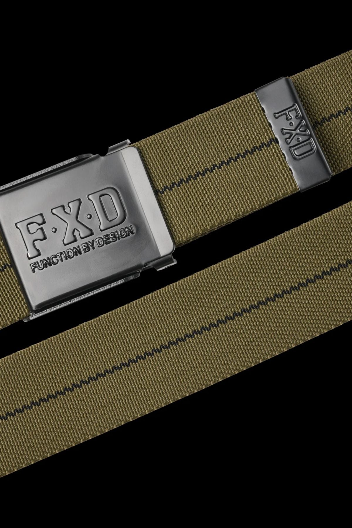 Close-up of the FXD CB-3 Stretch Canvas Work Belt in olive green with a black stripe, silver buckle engraved "F.X.D FUNCTION BY DESIGN," adjustable fit, and a small metal tag featuring the "F.X.D" logo.