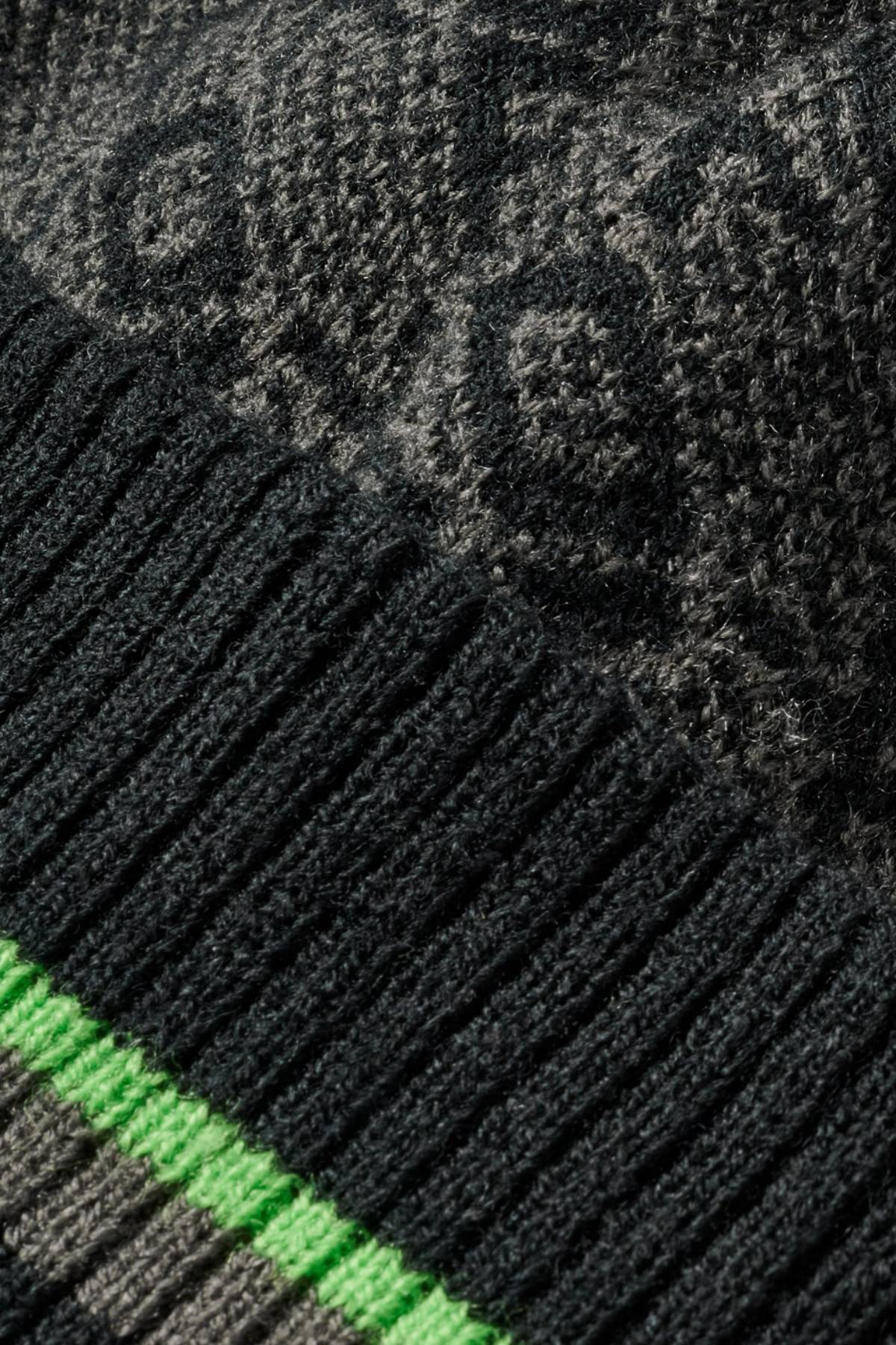 Close-up of the FXD CP-11 Jacquard Beanie, a winter accessory made from 100% Acrylic, showing a ribbed black section, bright green stripe, and patterned gray area with visible texture and stitching details.