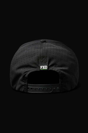 The FXD CP-12 Tech Baseball Cap features a lightweight, quick-drying polyester fabric. This black cap has a perforated design and an adjustable snap strap. A small "FXD" label in white and green adds subtle branding against the sleek black background.