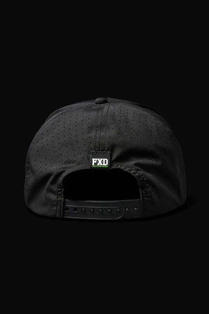 The FXD CP-12 Tech Baseball Cap, shown from the back on a solid black background, is black and perforated with a quick-drying design, an adjustable snap-back strap, and a small rectangular "FXD" logo tag above the opening.
