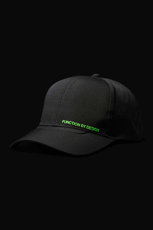 The FXD CP-12 Tech Baseball Cap is black with green "FUNCTION BY DESIGN" text on the front, has an adjustable snap-back, and is shown against a solid black background.