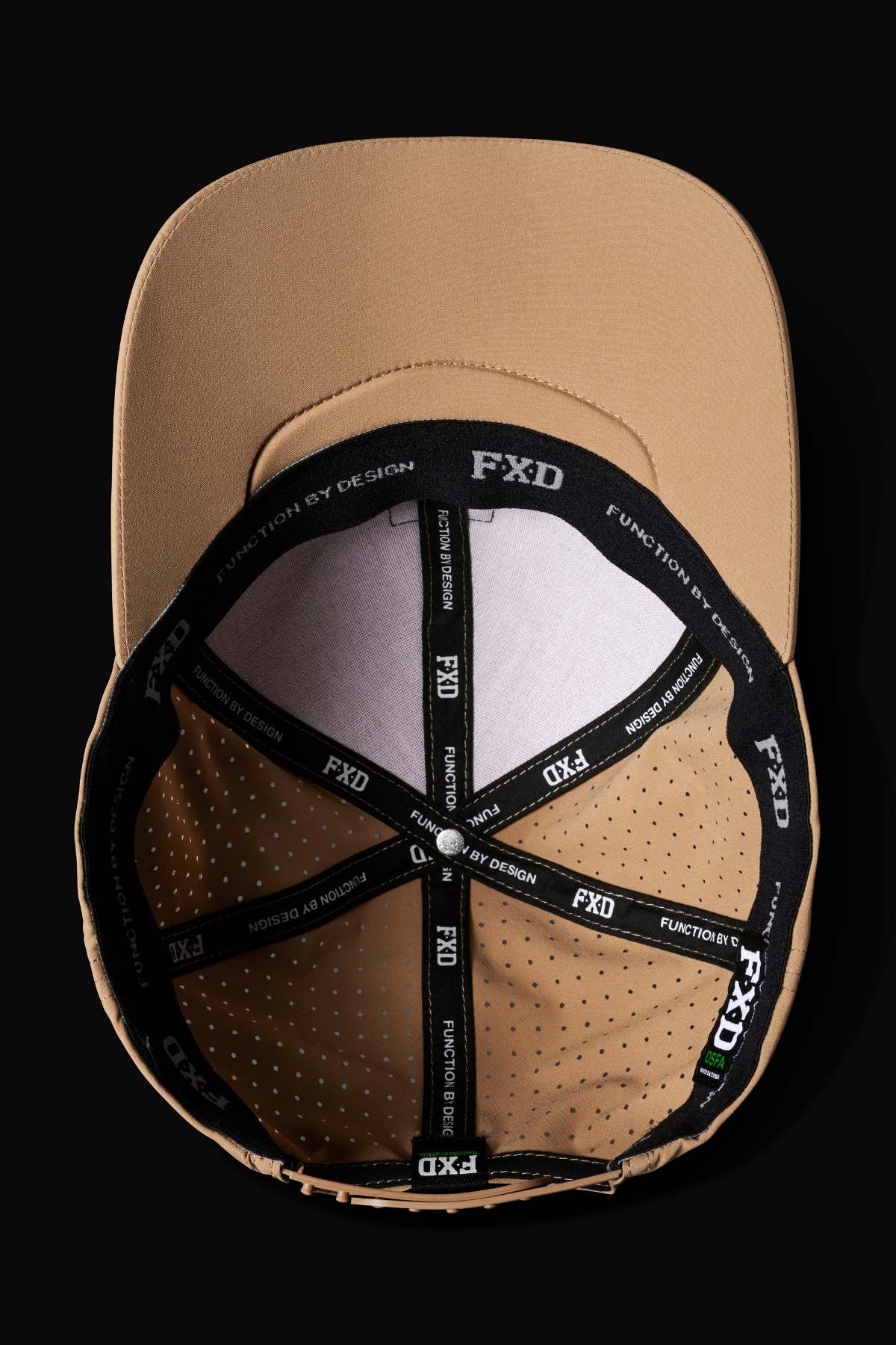 Top view of the FXD CP-12 Tech Baseball Cap in tan, showing black interior bands with white "FXD" and "FUNCTION BY DESIGN" text, ventilation holes, quick-dry polyester, and an adjustable snap-back strap.