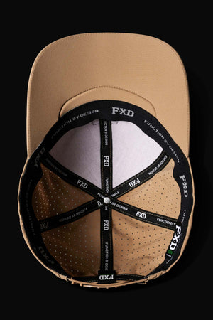 Top view of the FXD CP-12 Tech Baseball Cap in tan, showing black interior bands with white "FXD" and "FUNCTION BY DESIGN" text, ventilation holes, quick-dry polyester, and an adjustable snap-back strap.